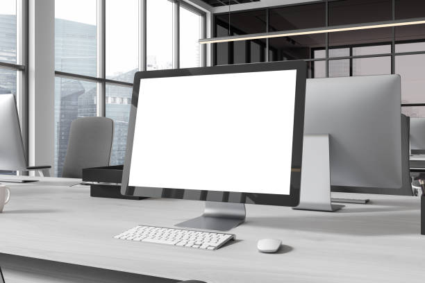 istock Office coworking interior with pc monitor on table with mockup display, window 2163972016