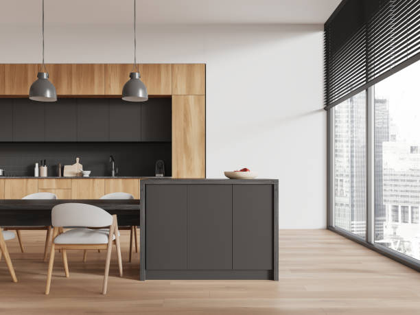 istock Modern kitchen interior with gray cabinets, wooden accents, and dining area, features large windows with city view, in minimalist design. Concept of contemporary living. 3D Rendering 2163972047