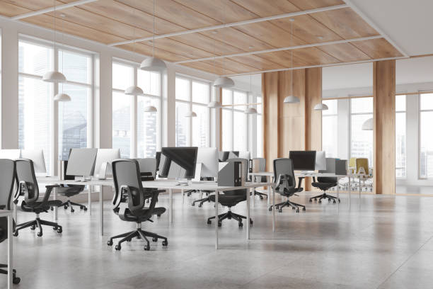 istock Modern co-working office space with desks and computers, natural light, wooden accents, open layout, business concept. 3D Rendering 2163972062