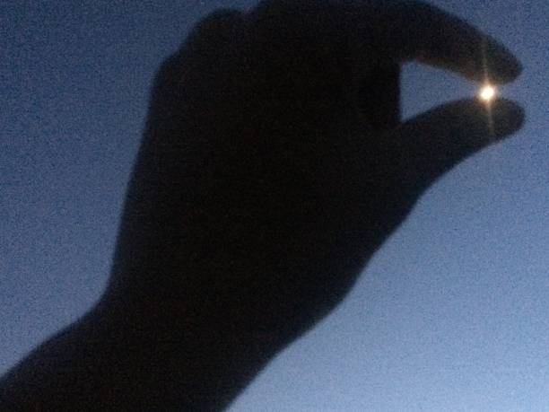 istock The Hand and the Moon 2163973746