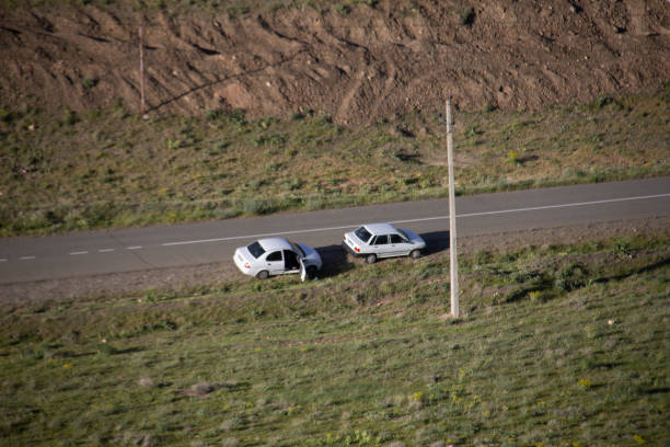 Driver changes a flat tyre on his four wheel drive vehicle in Mongolia