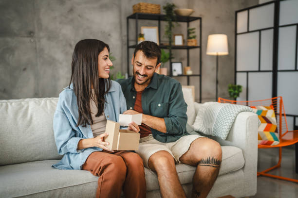 istock Girlfriend read greeting card thank you note from his boyfriend 2163975335