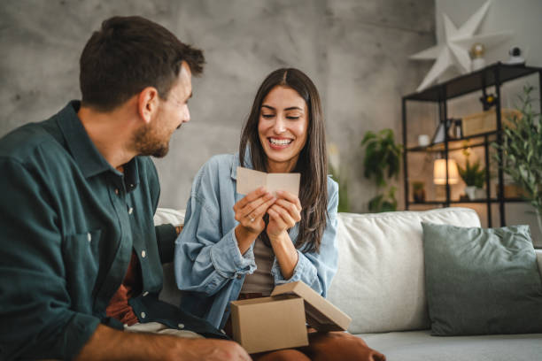 istock Girlfriend read greeting card thank you note from his boyfriend 2163975342