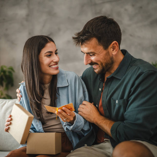 istock Girlfriend read greeting card thank you note from his boyfriend 2163975347
