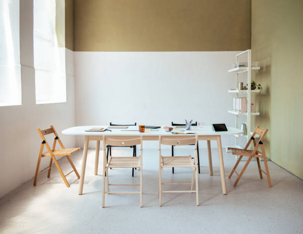 istock Minimalist Modern Office Meeting Room With Foldable Chairs 2163977114