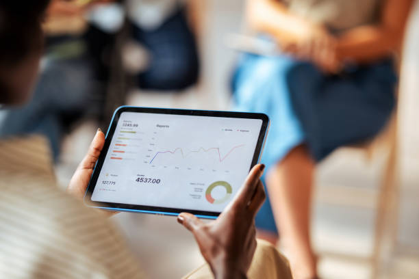 istock Business Meeting Showing Financial Reports on Tablet Screen 2163977163