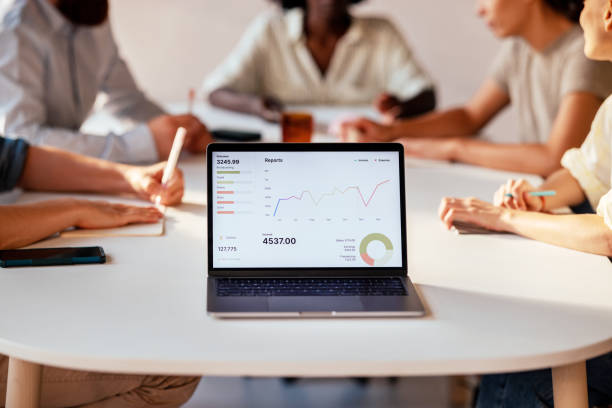 istock Team Analyzing Sales Data On Laptop During Office Meeting 2163977170