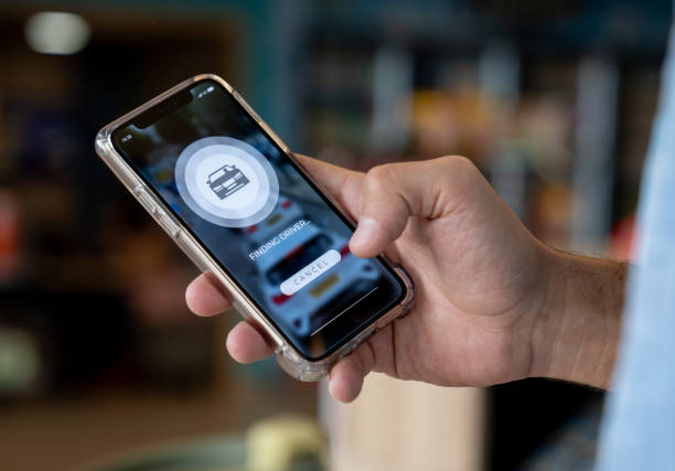 istock Transportation app user requesting a car on his cell phone 2163991662