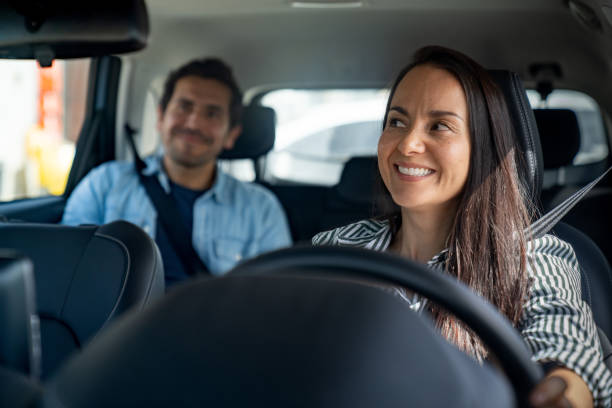 istock Happy crowdsourced taxi driver talking to a passenger 2163991695