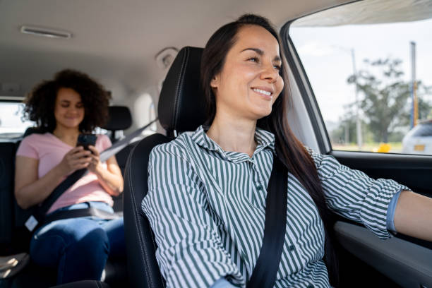 istock Happy crowdsourced taxi driver driving a passenger 2163991697