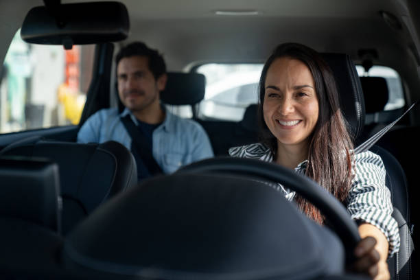 istock Happy crowdsourced taxi driver driving a passenger 2163991698