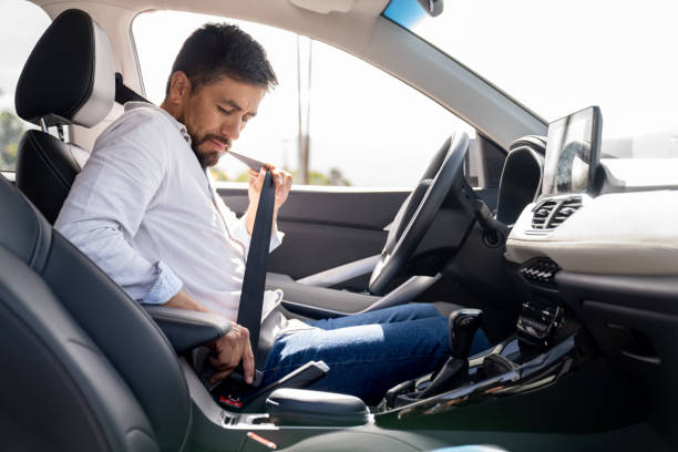 istock Car driver fastening his seat belt 2163991699