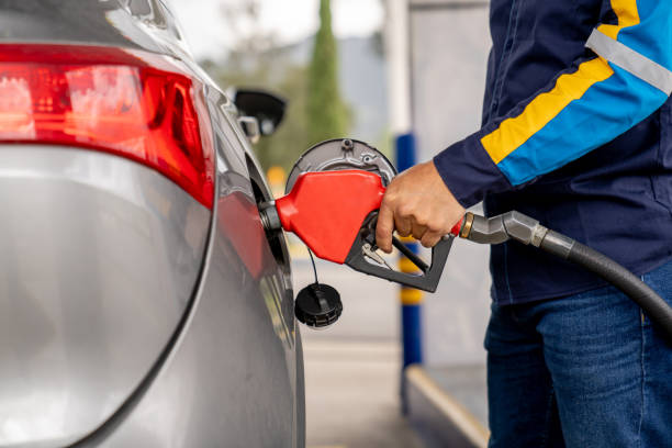 istock Attendant refueling a car at a gas station 2163991728