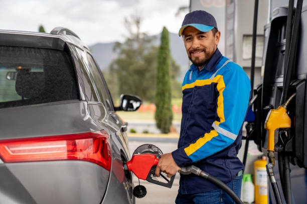 istock Man working at a petrol station refueling a car 2163991736