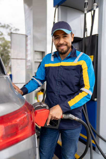 istock Gas station attendant refueling a car 2163991753