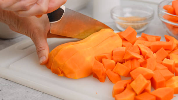 istock Butternut squash soup recipe. Raw vegetables close-up on the kitchen table. Peeled  and seedless butternut squash close-up on a cutting board 2163992381