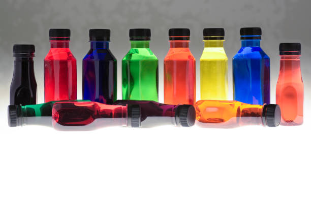 Bright coloured plastic bottles with colourful liquid showing colour changes has light passes through them