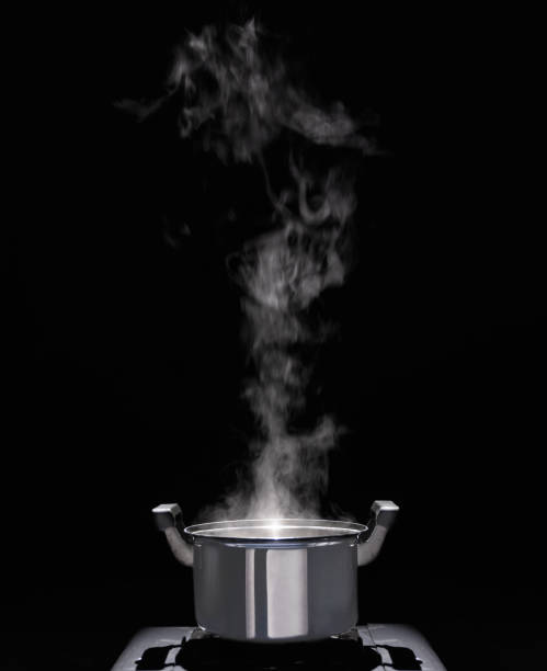 istock Steam over cooking pot in kitchen on dark background. 2163994624