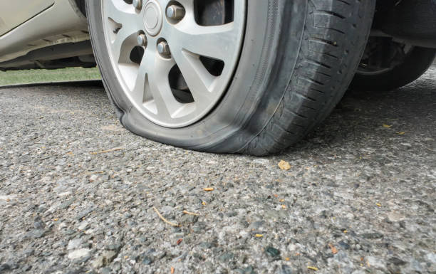 istock Car flat tire on the rural road. 2163994629