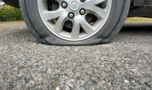 istock Car flat tire on the rural road. 2163994631