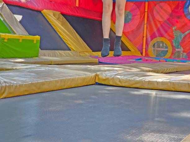 istock Children jumping on trampoline and having fun in park 2163996950