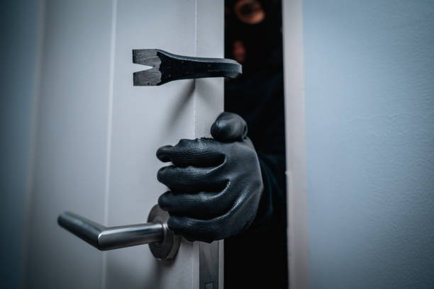 istock Thief in uniform black jacket various action housebreak. The Robber terrorism criminal escapes with balaclava and crowbar entering a house for stealing Housebreak at night 2163996966