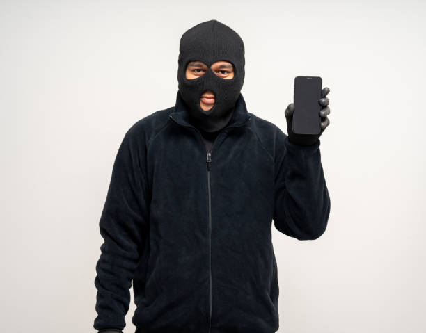 istock Thief in uniform black jacket various pose on isolated background. The Robber terrorism criminal escapes with balaclava and crowbar entering a house for stealing Housebreak 2163997124