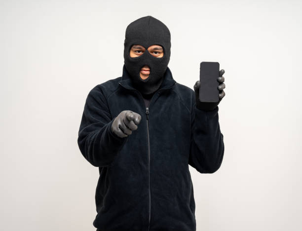 istock Thief in uniform black jacket various pose on isolated background. The Robber terrorism criminal escapes with balaclava and crowbar entering a house for stealing Housebreak 2163997300