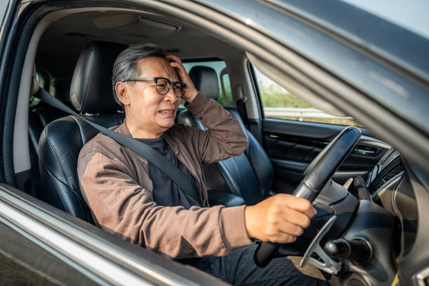 istock Senior asian man has broken down car on the road he feeling serious and stressed. Look for someone help. Mature Driving during rush hour But the traffic is very congested. Shocked face 2163998329