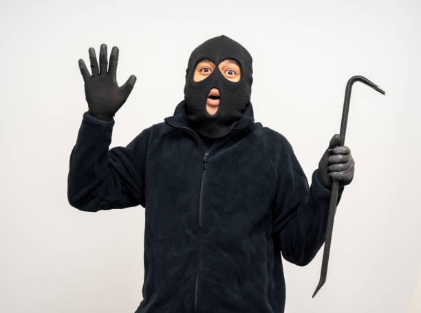 istock Thief in uniform black jacket various pose on isolated background. The Robber terrorism criminal escapes with balaclava and crowbar entering a house for stealing Housebreak 2163998366