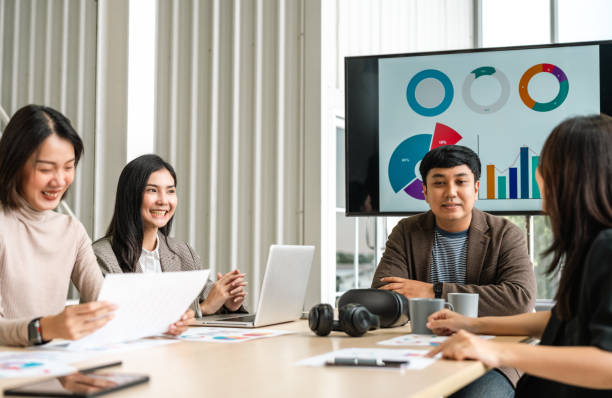 istock Asian business start up freelance people team analyzing statistics financial. Group Team of businesspeople man and woman Meeting Conference Discussion various topic Corporate Concept in office. 2163998373
