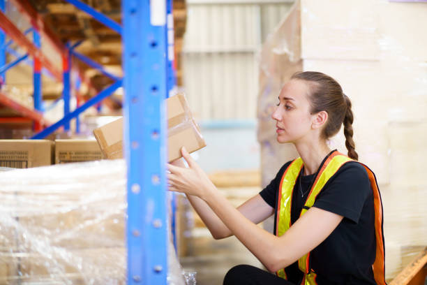 istock Female caucasian white warehouse worker inspecting the inventory. 2164004753