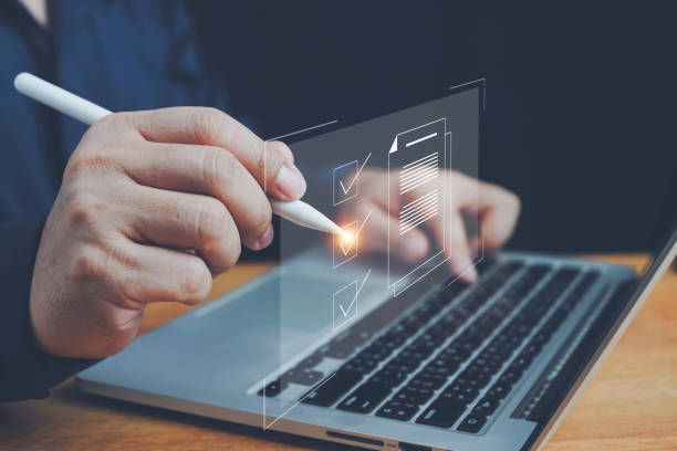 istock Checklist, Digital and smart checklist document concept, Businessman marking on e-checklist on virtual screen and use laptop document management with modern intelligent online systems high security. 2164007519