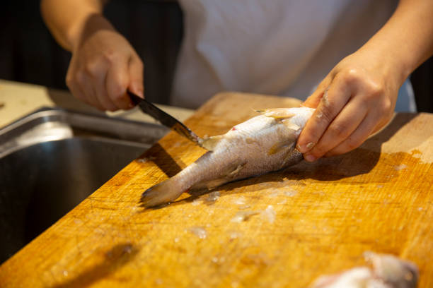 istock A man is killing fish in the kitchen 2164013538