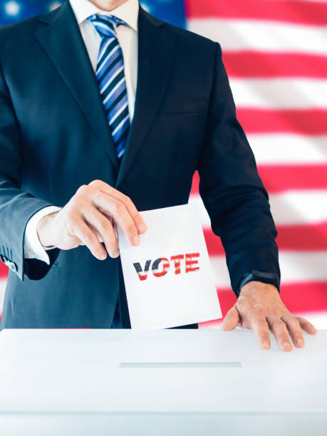 istock Businessman Voting in Front of Flag 2164014054