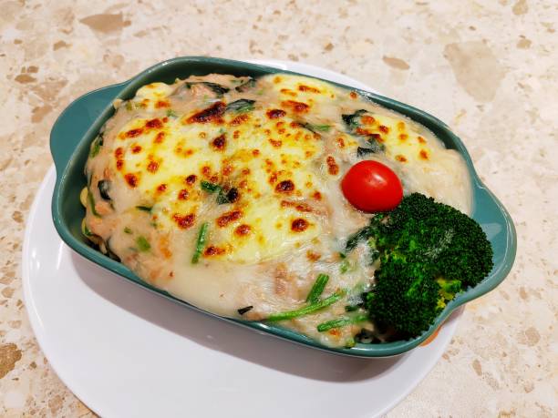 Delicious quiche with broccoli, cheese, chicken, spices and herbs on a dark concrete background