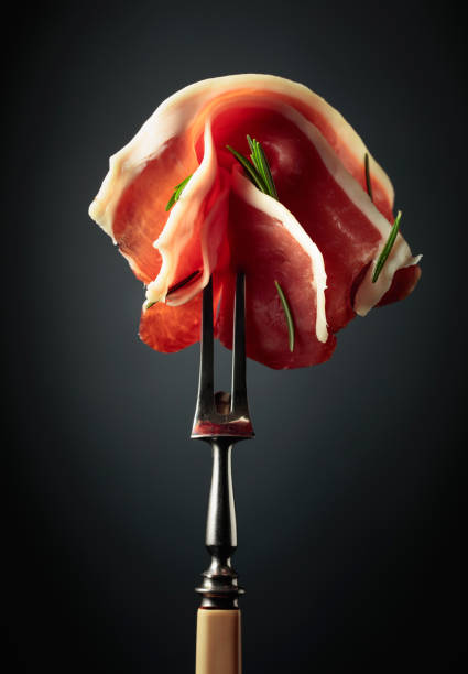 istock Sliced prosciutto with rosemary. 2164015698