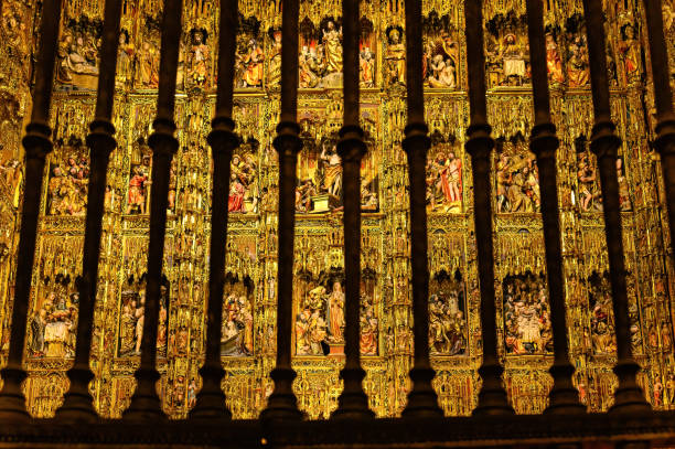 Seville, Spain - July 20, 2024: Main altar behind bars. The Cathedral of Saint Mary of the See is a Unesco World Heritage Site.