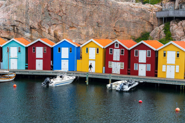 Sailboats and motorboats moored in a calm harbor in the gothenburg archipelago, sweden, with reflections on the water