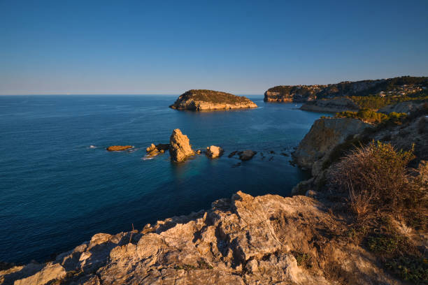 istock rocky bay calm blue sea 2164020534