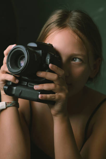 portrait a little girl with photo camera in her hands