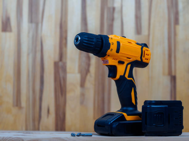 istock A screwdriver-drill against a wood background, ready for work, is ideal for repairs and construction in the country or at home 2164024545