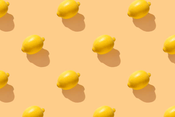 istock Lemon on yellow pastel soft color with long shadows 2164025475
