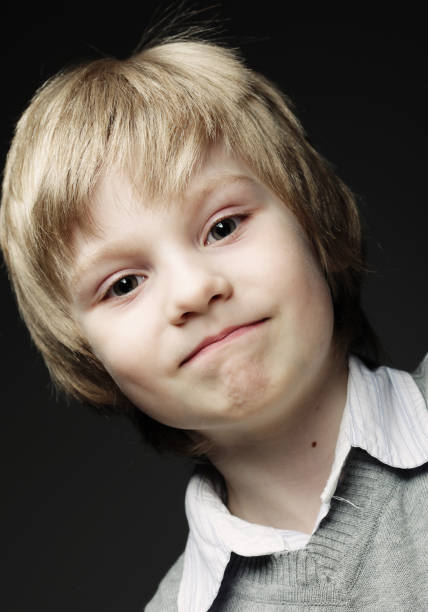 Image of funny young boy over gray background