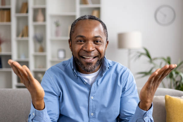 istock Happy man smiling and looking into camera during video call at home 2164029126