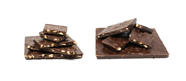 istock Broken nut chocolate bar stack, isolated. Milk chocolate square pieces, cubes, small bloks pile, choco 2164032756