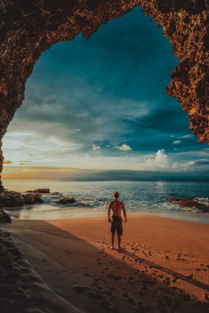 Travel people walking from mountain cave to tropical beach