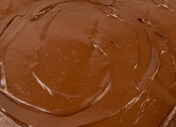 Women mixing ingredients with electric mixer to make chocolate cake or brownies