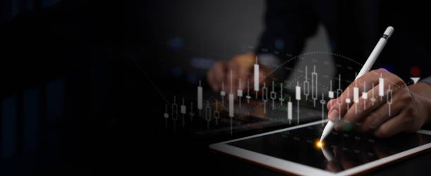istock Hand using a digital pen to analyze market graphs on a tablet. Financial trading, market analysis, technology innovation. Data-driven investment strategy. 2164034634