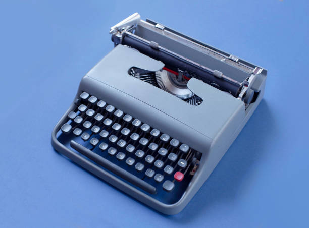 istock old matte blue typewriter isolated on a plain teal background with a lot of aesthetics 2164036192